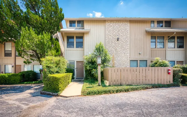 a front view of a house with a yard and a garage