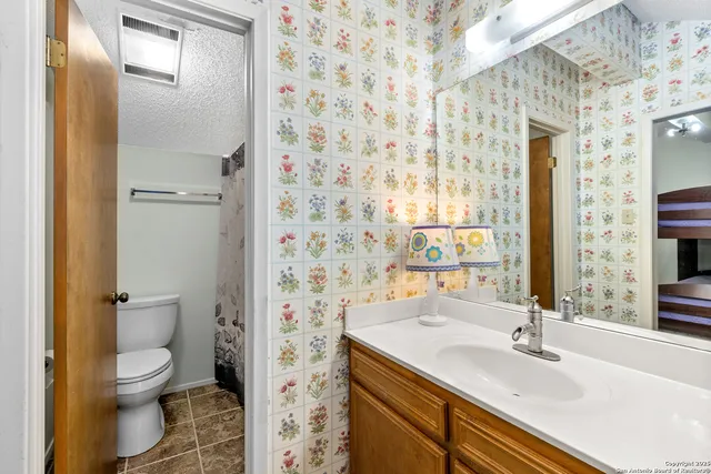 a view of a chairs and table in patio with wooden fence