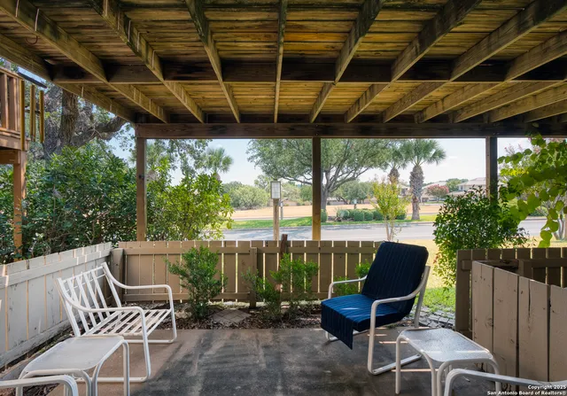 a view of a patio with a table and chairs