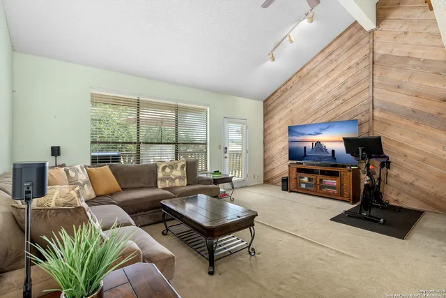 a living room with furniture gym equipment and a large window