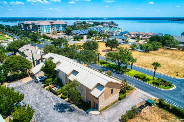 an aerial view of a house with a lake view