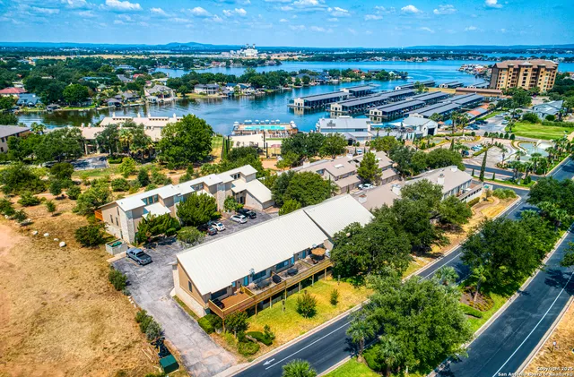 an aerial view of a house with a lake view