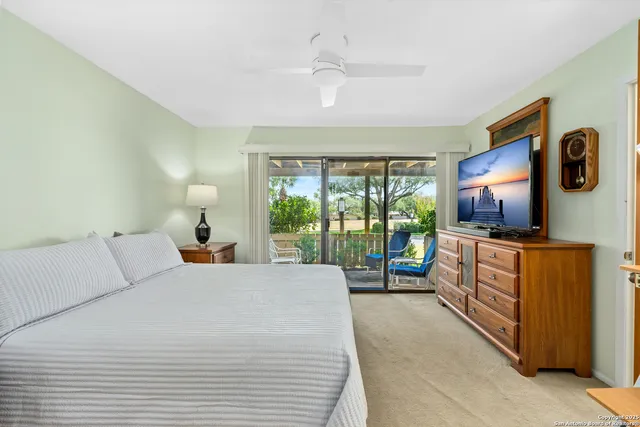 a bed room with a bed and a large window