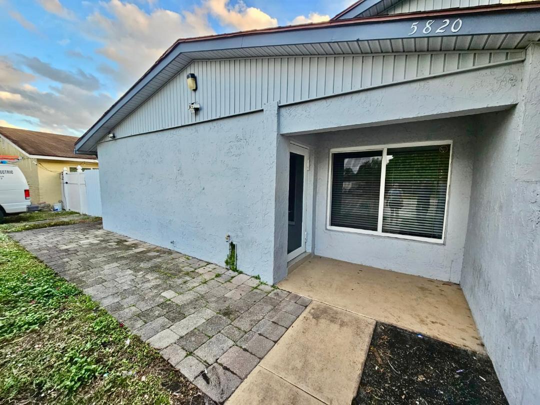 5820 Albert Road West Palm Beach, FL 33415 - Photo 1 of 14 a front view of a house with a yard