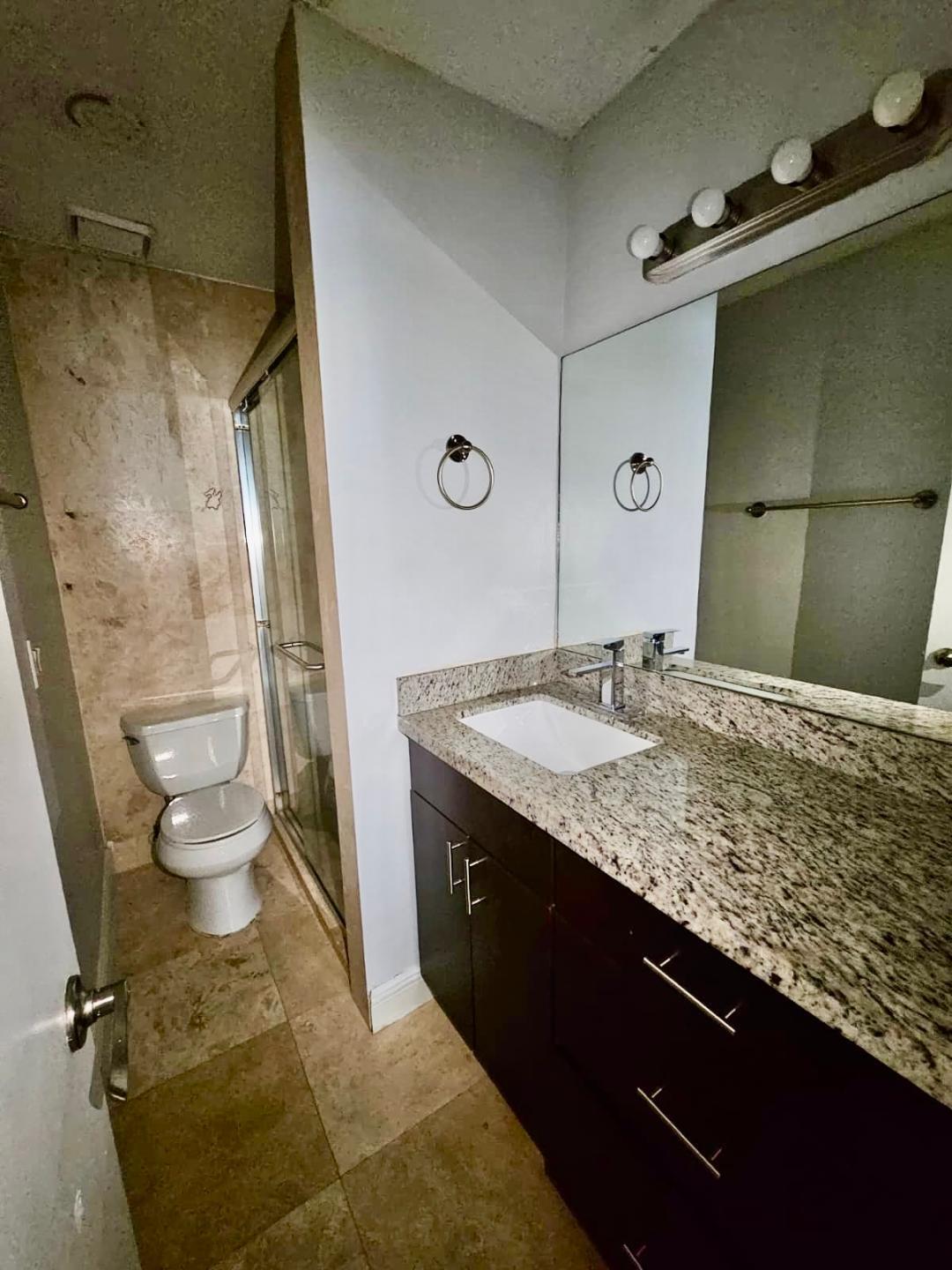 5820 Albert Road West Palm Beach, FL 33415 - Photo 11 of 14 a bathroom with a granite countertop sink toilet and shower