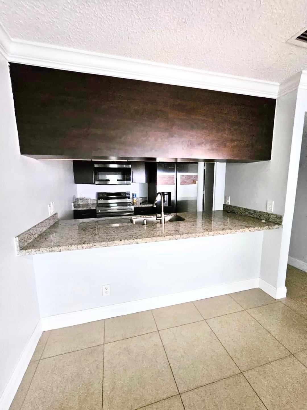 5820 Albert Road West Palm Beach, FL 33415 - Photo 5 of 14 a kitchen with a stove and a microwave