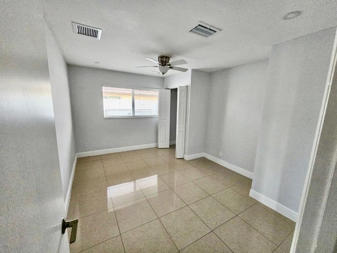 5820 Albert Road West Palm Beach, FL 33415 - Photo 10 of 14 an empty room with windows and fan