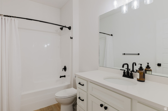 287 East 1000 North Logan, UT 84321 - Photo 31 of 41 Bathroom featuring a white vanity with integrated sink, a large wall-mounted mirror, and a full-size bathtub with a shower