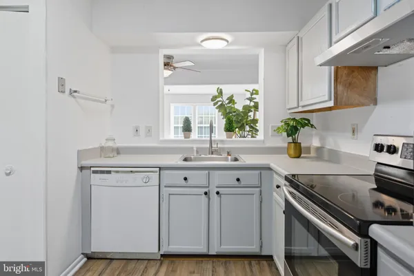 a kitchen with cabinets appliances and a sink