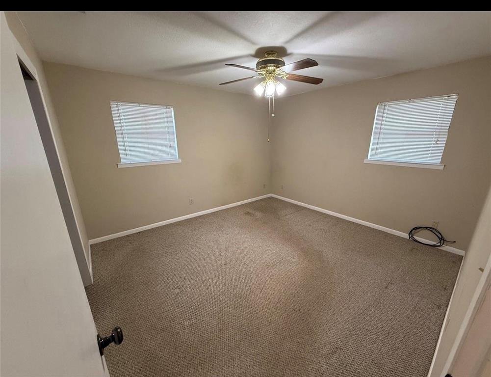 105 West Elm Gustine, TX 76455 - Photo 15 of 21 Empty room with carpet and a ceiling fan