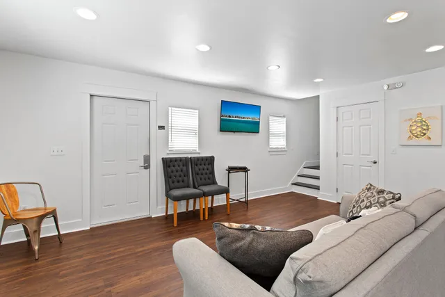 a living room with furniture and a wooden floor