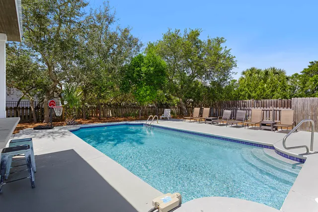 a view of a swimming pool with chairs in patio