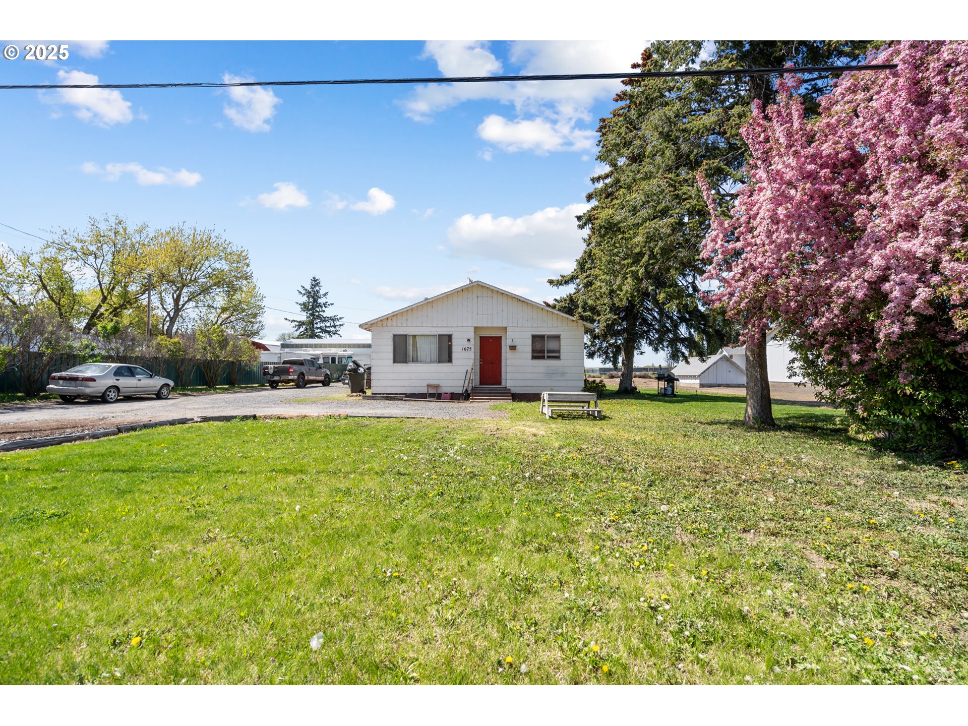 1675 Northwest 11th Street Hermiston, OR 97838 - Photo 1 of 33 a house view with swimming pool and trees in the background