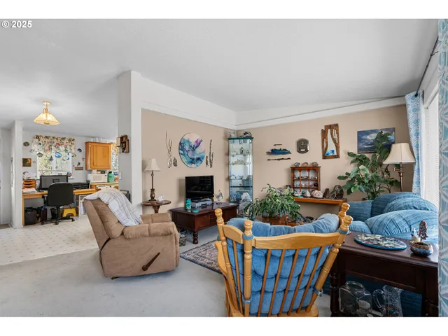 a kitchen with stainless steel appliances kitchen island granite countertop a table chairs sink and cabinets