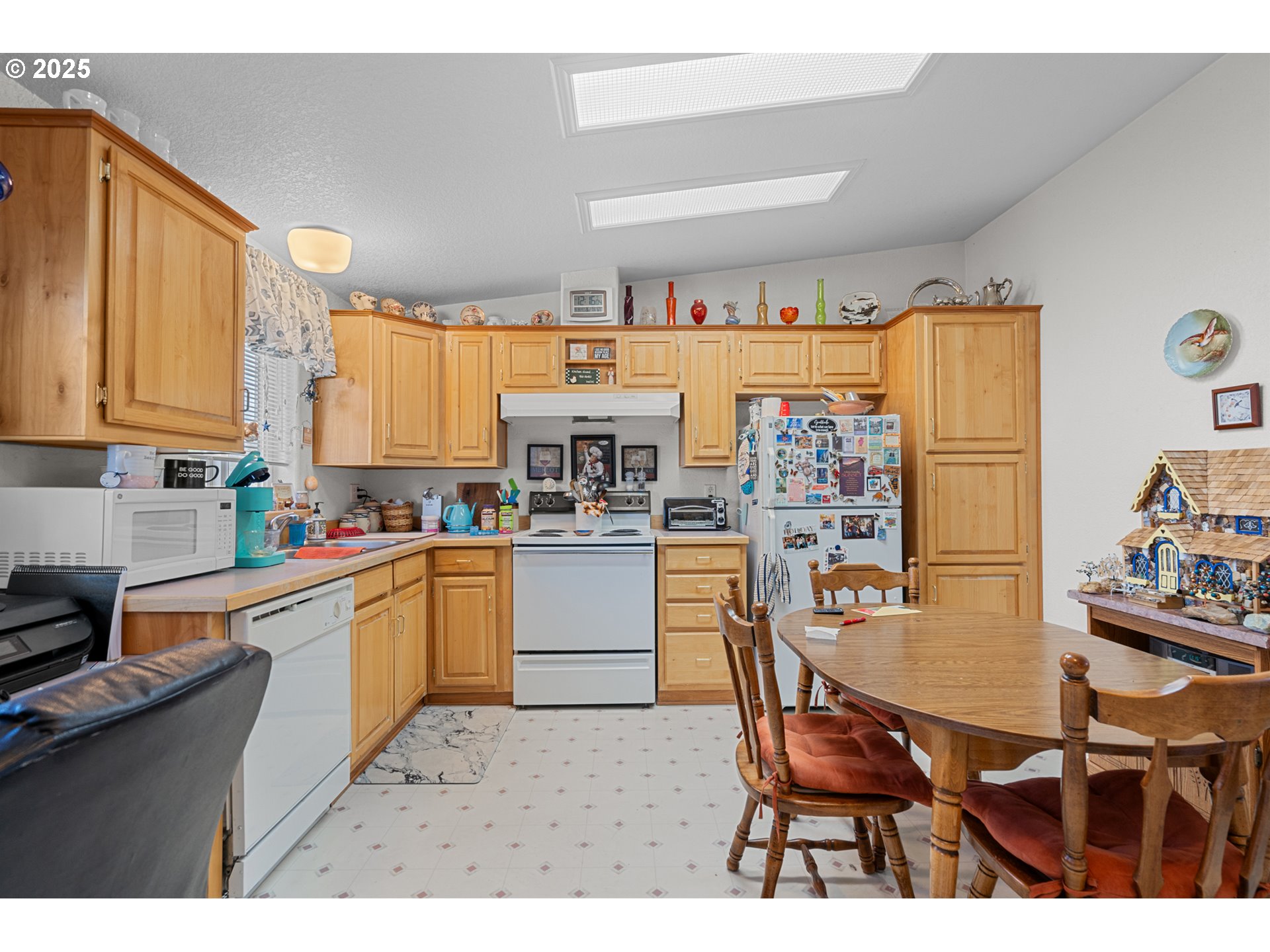 1675 Northwest 11th Street Hermiston, OR 97838 - Photo 18 of 33 a kitchen with stainless steel appliances kitchen island granite countertop a table chairs sink and cabinets