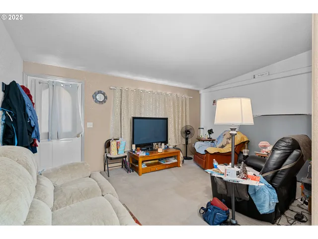 a kitchen with a refrigerator and a stove top oven