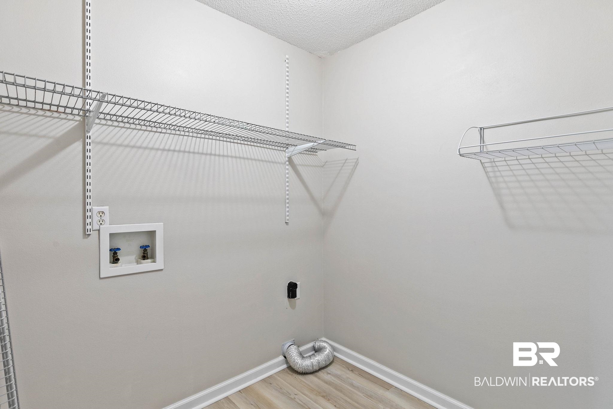 35650 Spring Road North Stapleton, AL 36578 - Photo 49 of 70 Laundry room with light wood-type flooring, a textured ceiling, and washer hookup