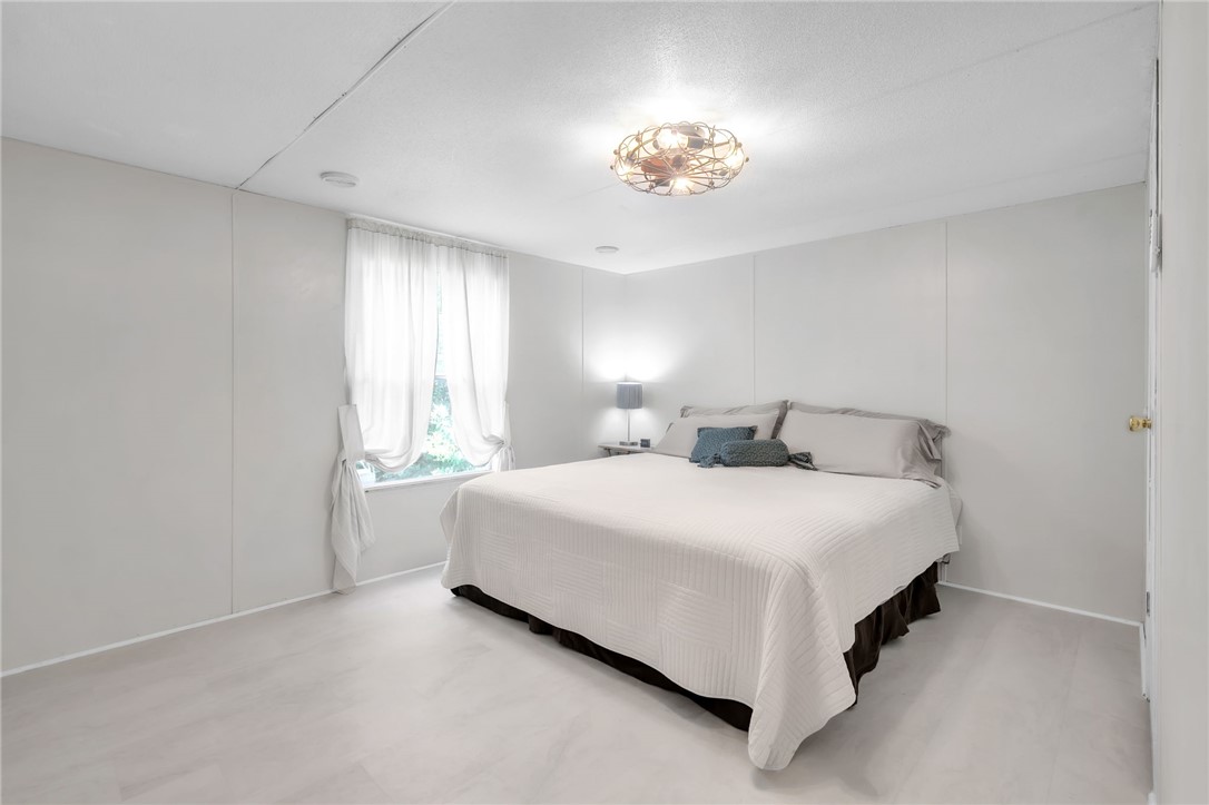 506 Charlies Creek Road Iva, SC 29655 - Photo 14 of 28 A well-lit bedroom offering a cozy retreat with neutral tones and durable flooring.