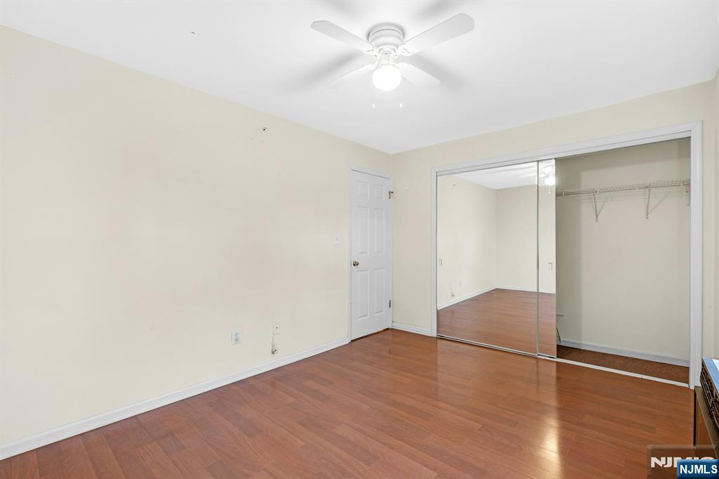 1419 Faulkner Court Mahwah, NJ 07430 - Photo 14 of 18 an empty room with wooden floor and fan