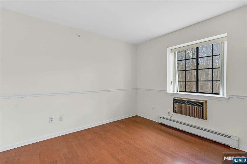 1419 Faulkner Court Mahwah, NJ 07430 - Photo 15 of 18 an empty room with wooden floor and windows