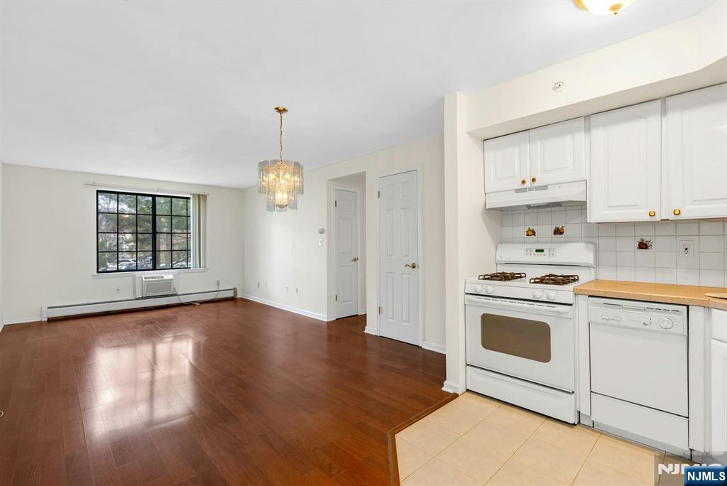1419 Faulkner Court Mahwah, NJ 07430 - Photo 3 of 18 a kitchen with granite countertop a stove a sink dishwasher and a refrigerator with wooden floors