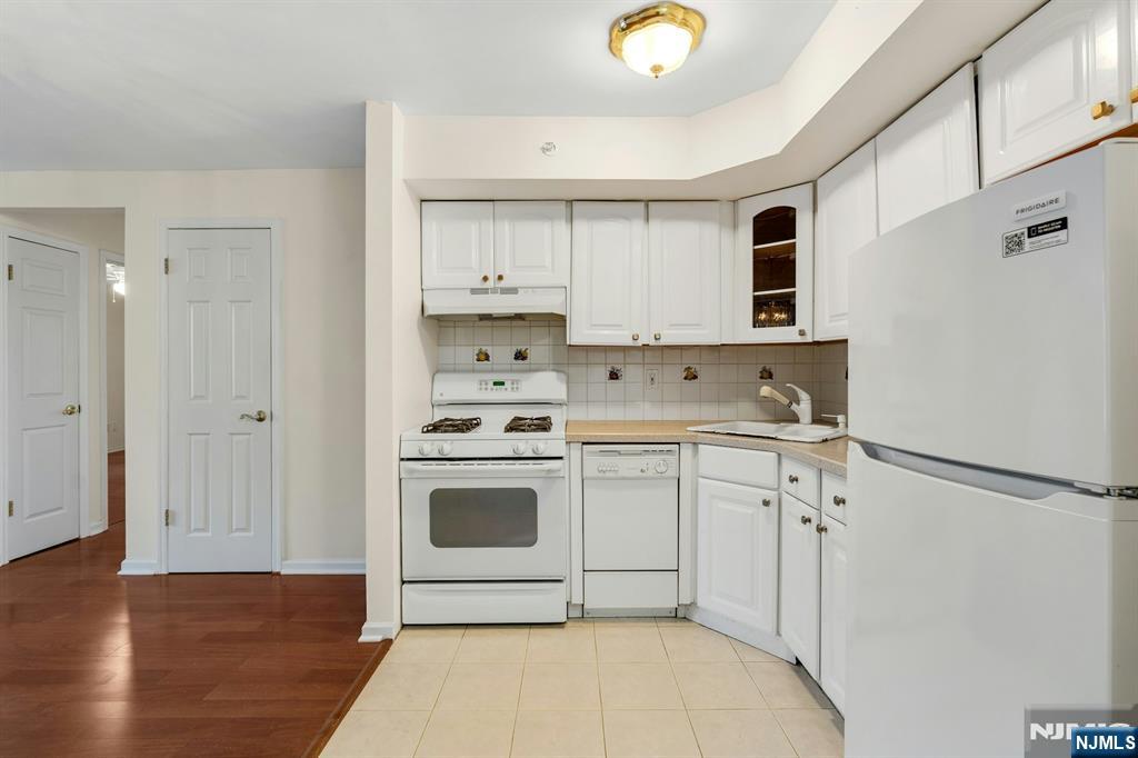1419 Faulkner Court Mahwah, NJ 07430 - Photo 4 of 18 a kitchen with stainless steel appliances granite countertop a stove a sink and a refrigerator with white cabinets