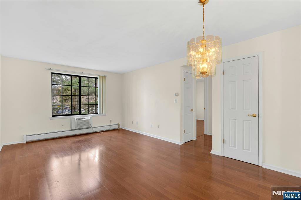 1419 Faulkner Court Mahwah, NJ 07430 - Photo 6 of 18 a view of an empty room with wooden floor and a window