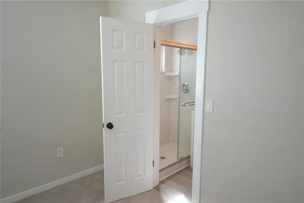 a view of a bathroom with white door