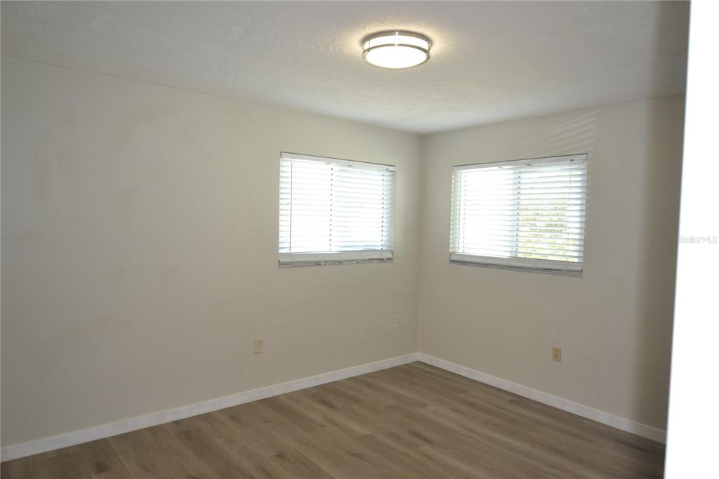 746 Barbara Street Palm Harbor, FL 34684 - Photo 17 of 54 an empty room with wooden floor and windows