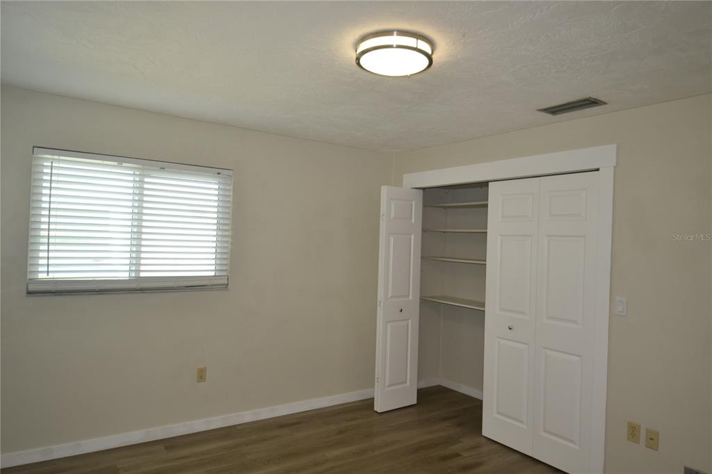 746 Barbara Street Palm Harbor, FL 34684 - Photo 18 of 54 an empty room with wooden floor and window