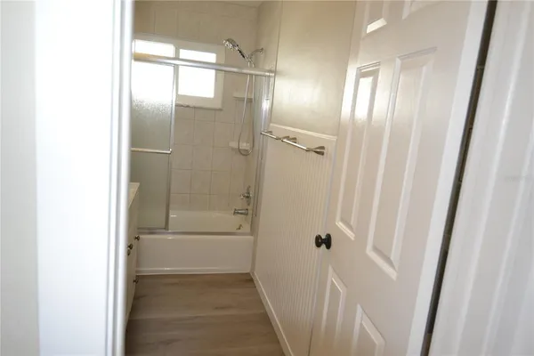 a bathroom with a shower and a sink