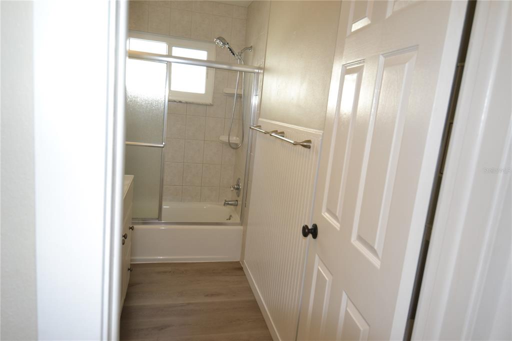 746 Barbara Street Palm Harbor, FL 34684 - Photo 21 of 54 a bathroom with a glass shower door