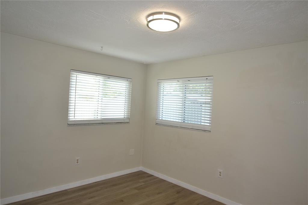 746 Barbara Street Palm Harbor, FL 34684 - Photo 24 of 54 an empty room with wooden floor and windows