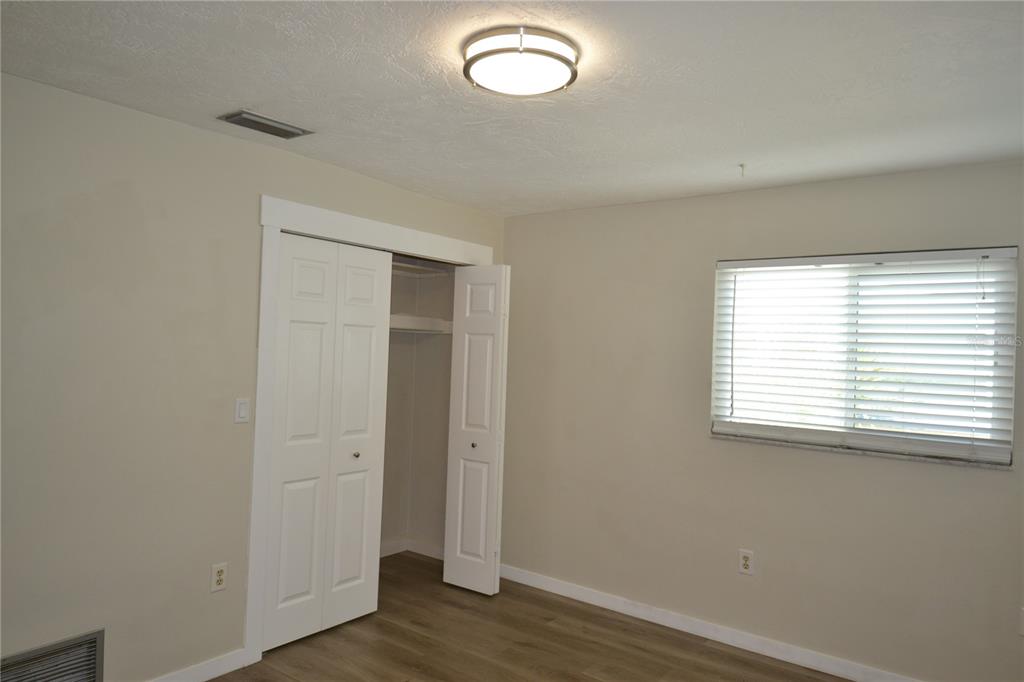 746 Barbara Street Palm Harbor, FL 34684 - Photo 25 of 54 an empty room with wooden floor and windows