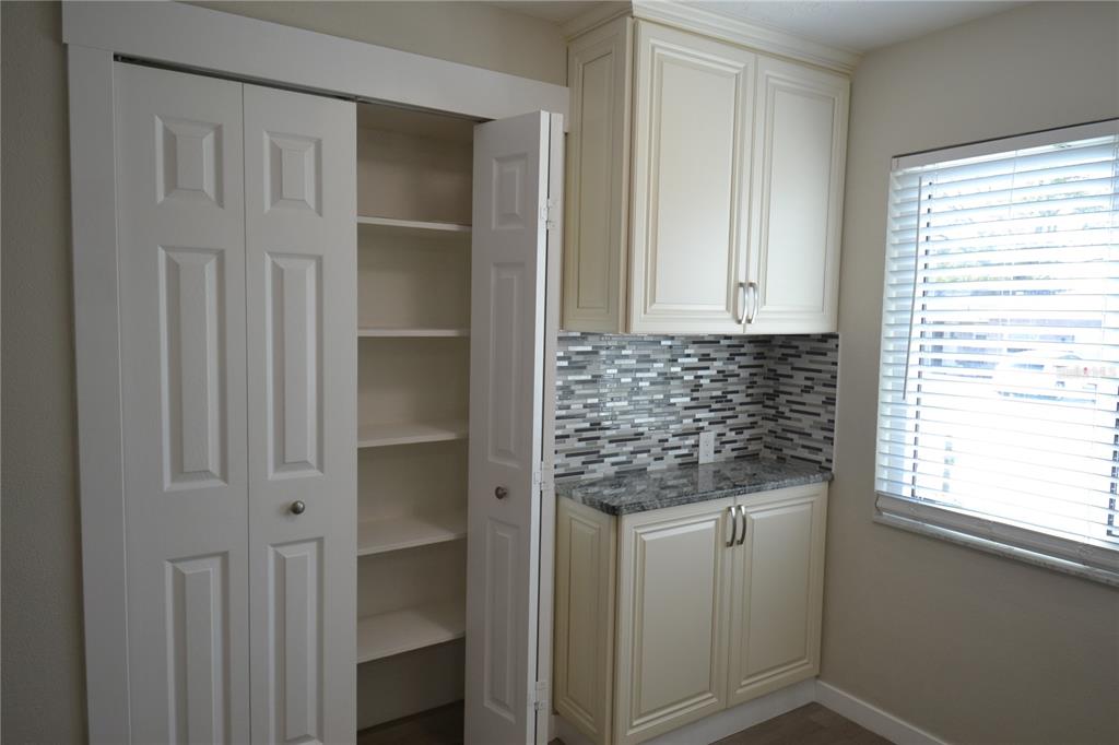 746 Barbara Street Palm Harbor, FL 34684 - Photo 31 of 54 a bathroom with a granite countertop sink and a window