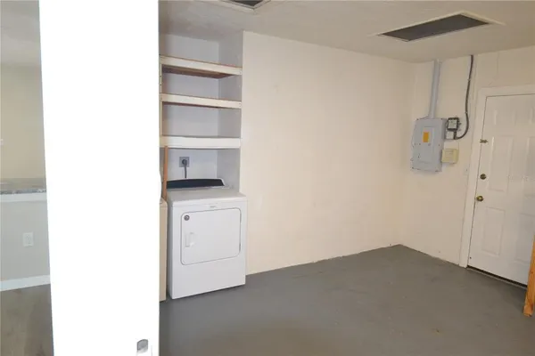a view of walk in closet with empty racks