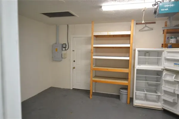 a kitchen with white cabinets and stove