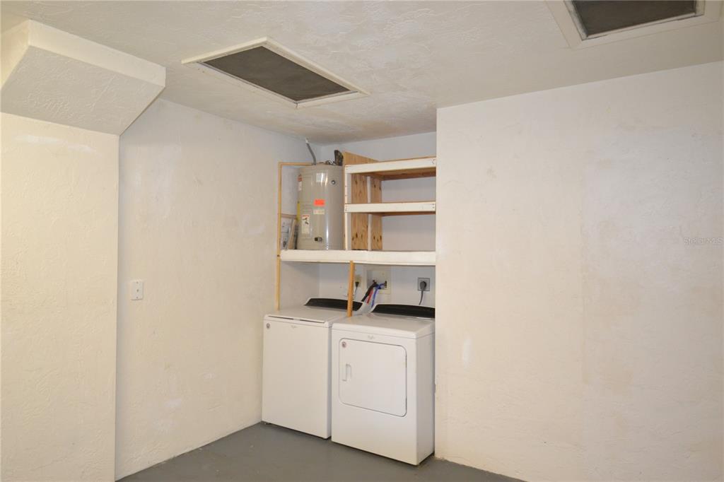746 Barbara Street Palm Harbor, FL 34684 - Photo 35 of 54 a kitchen with white cabinets and stove