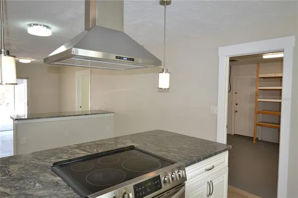 a kitchen with granite countertop a stove and a sink