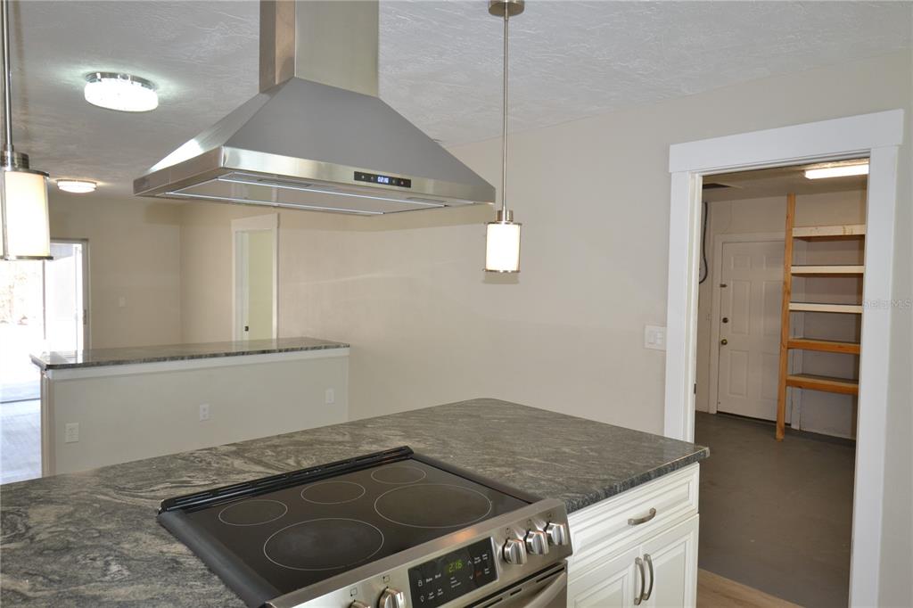 746 Barbara Street Palm Harbor, FL 34684 - Photo 4 of 54 a kitchen with granite countertop a stove and a sink