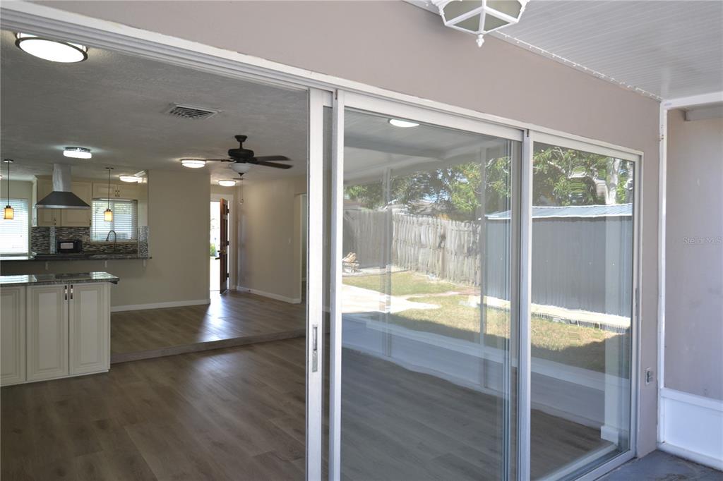 746 Barbara Street Palm Harbor, FL 34684 - Photo 51 of 54 a view of a hallway with wooden floor and a kitchen view