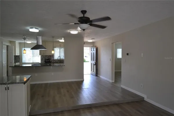 a view of a kitchen with marble kitchen and stainless steel appliances