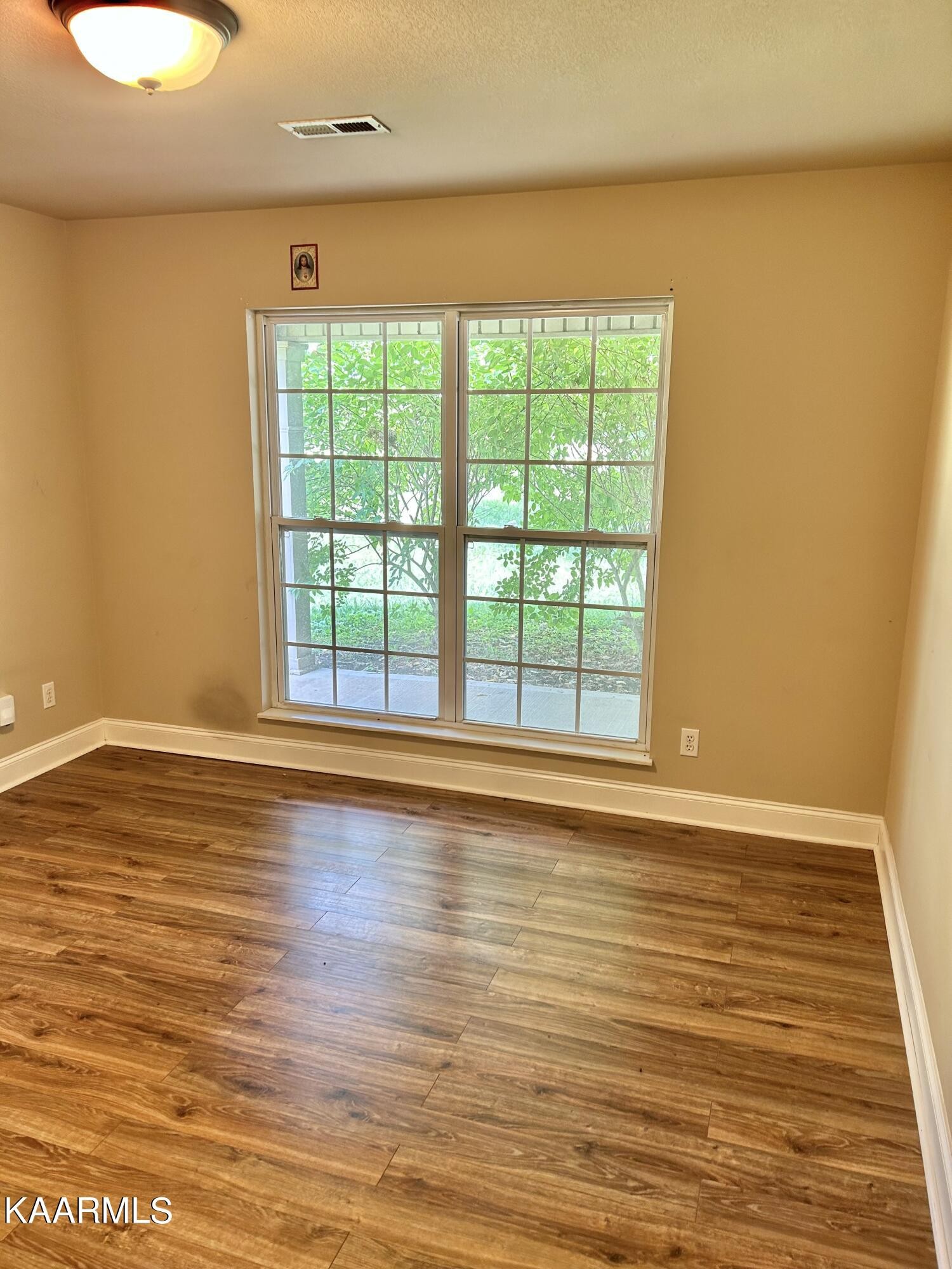 2309 Big Springs Road Maryville, TN 37801 - Photo 13 of 19 a view of an empty room with wooden floor and a window
