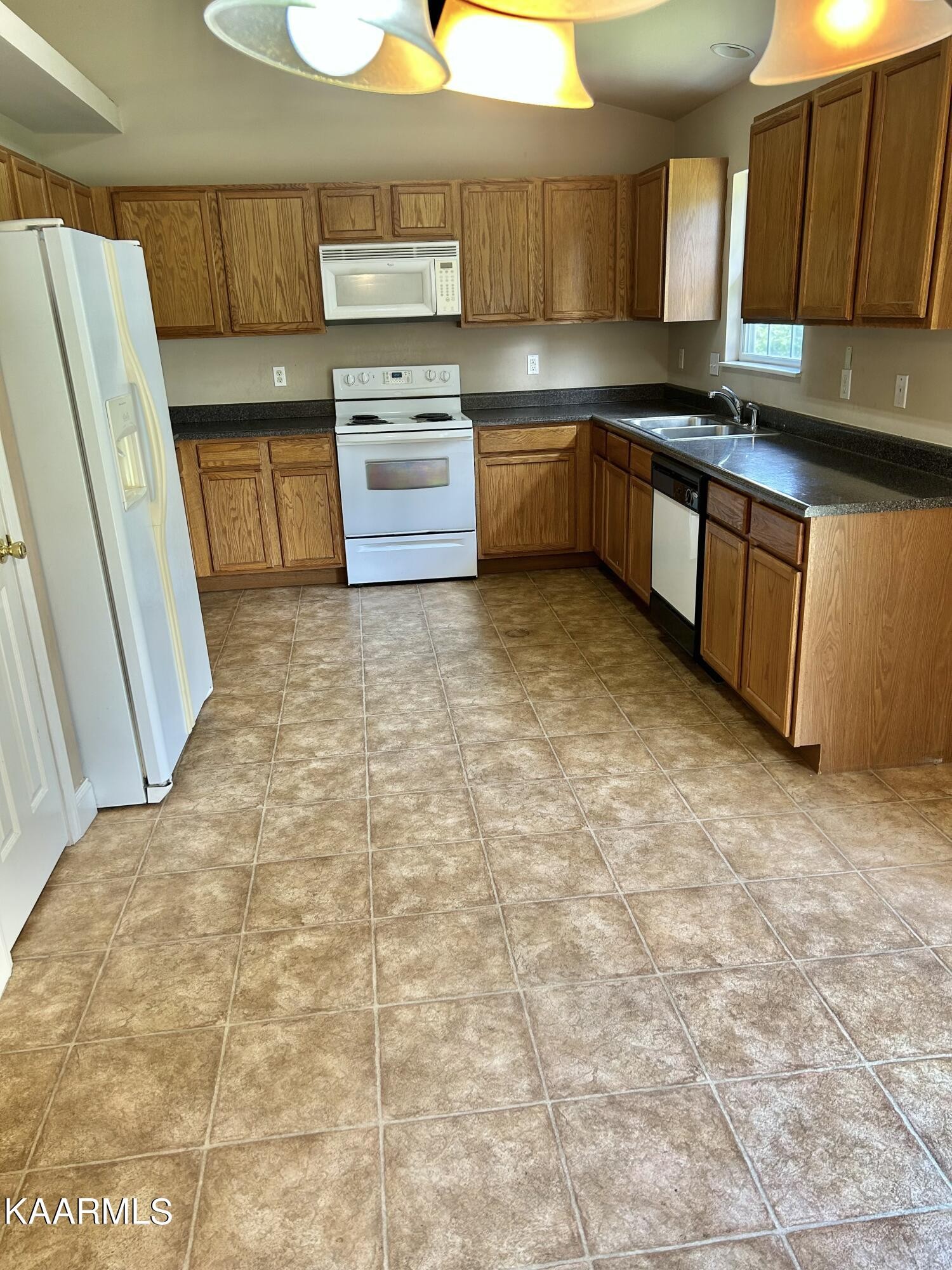 2309 Big Springs Road Maryville, TN 37801 - Photo 16 of 19 a large kitchen with granite countertop a sink a stove top oven a washer and dryer