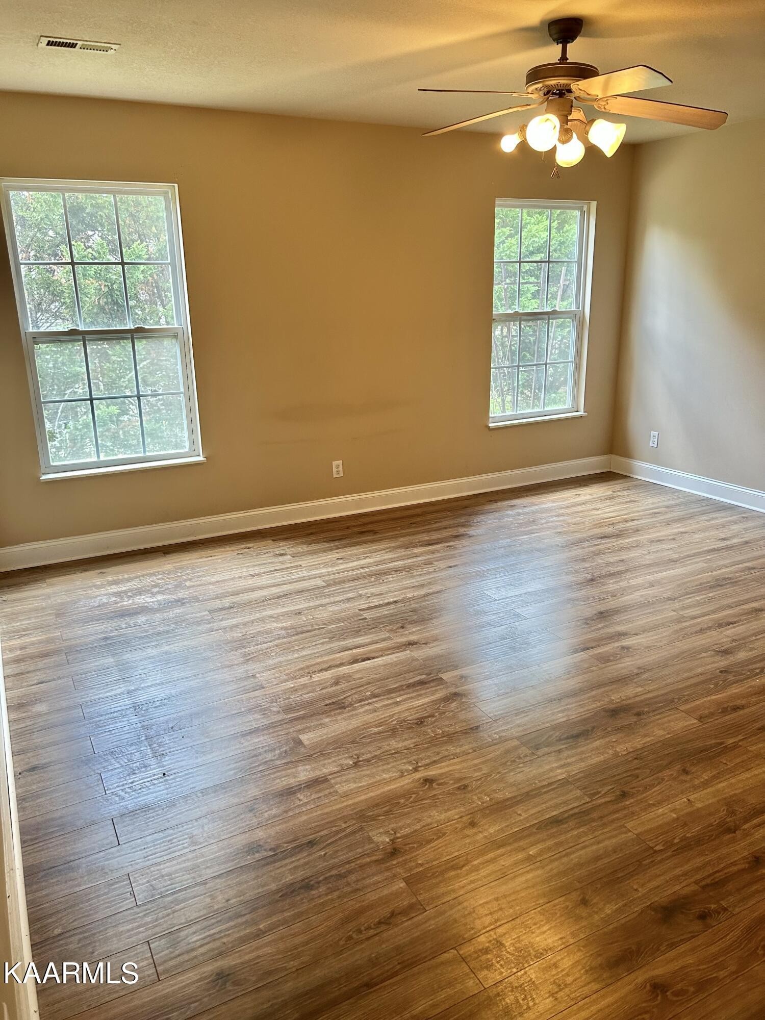 2309 Big Springs Road Maryville, TN 37801 - Photo 5 of 19 an empty room with wooden floor chandelier and windows