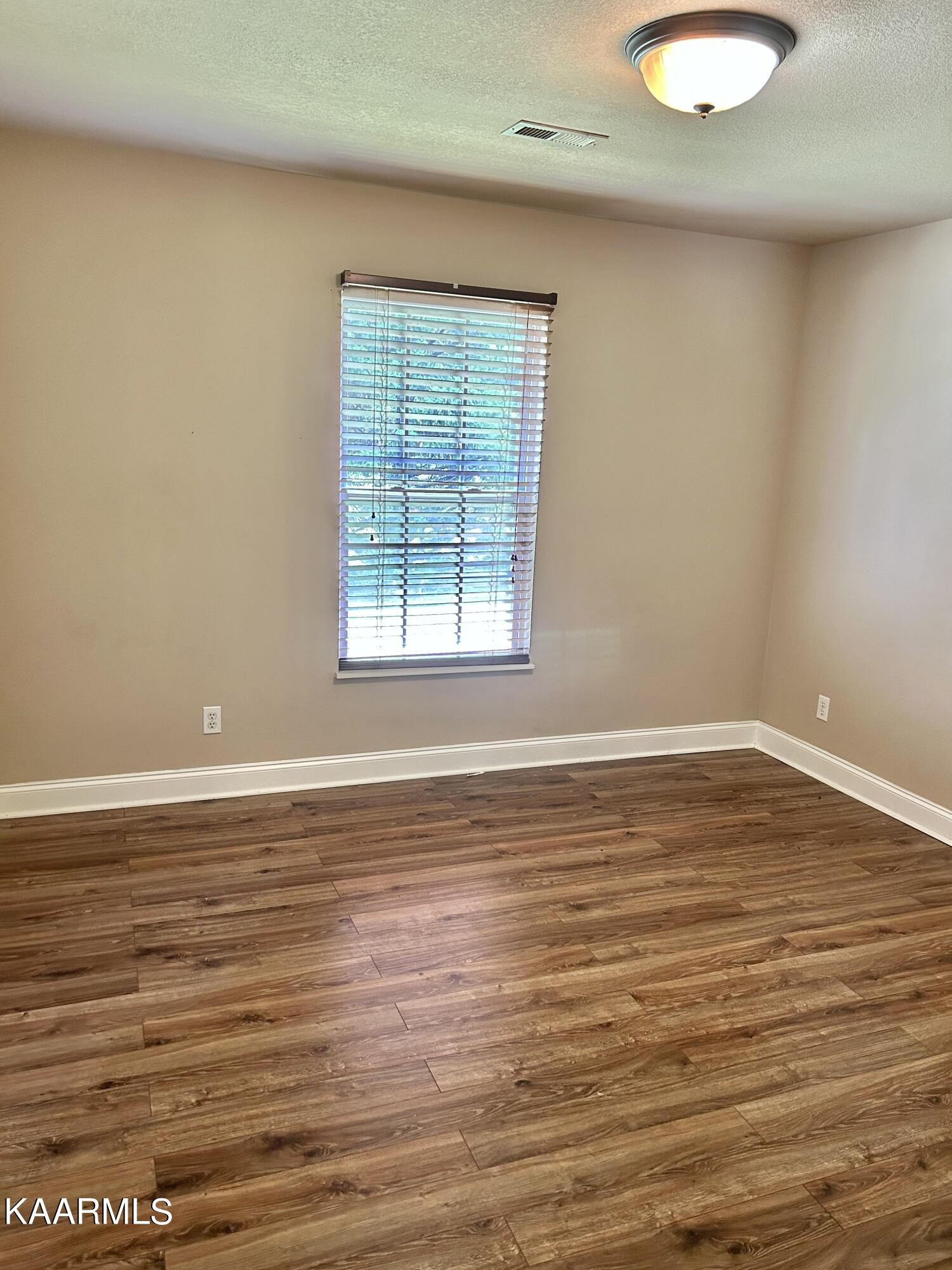 2309 Big Springs Road Maryville, TN 37801 - Photo 7 of 19 a view of an empty room with wooden floor and a window