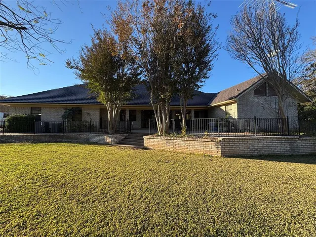 a view of a house with a yard and sitting area