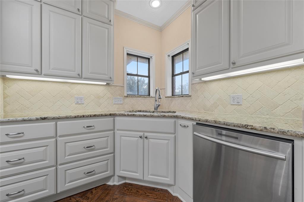 2510 Oak Ridge Clifton, TX 76634 - Photo 8 of 26 a kitchen with granite countertop cabinets and white appliances