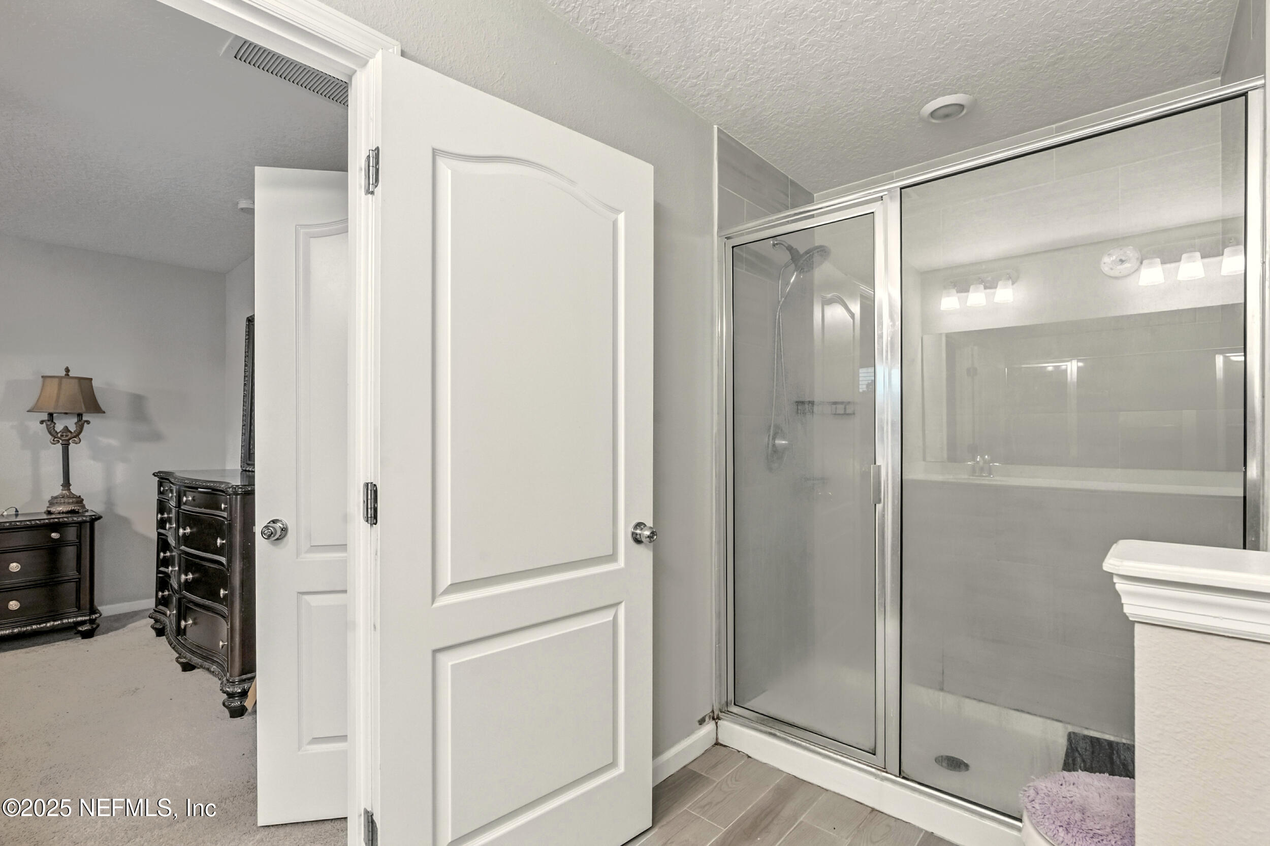 1330 Salt Ridge Avenue Jacksonville, FL 32218 - Photo 17 of 27 a bathroom with a glass shower door