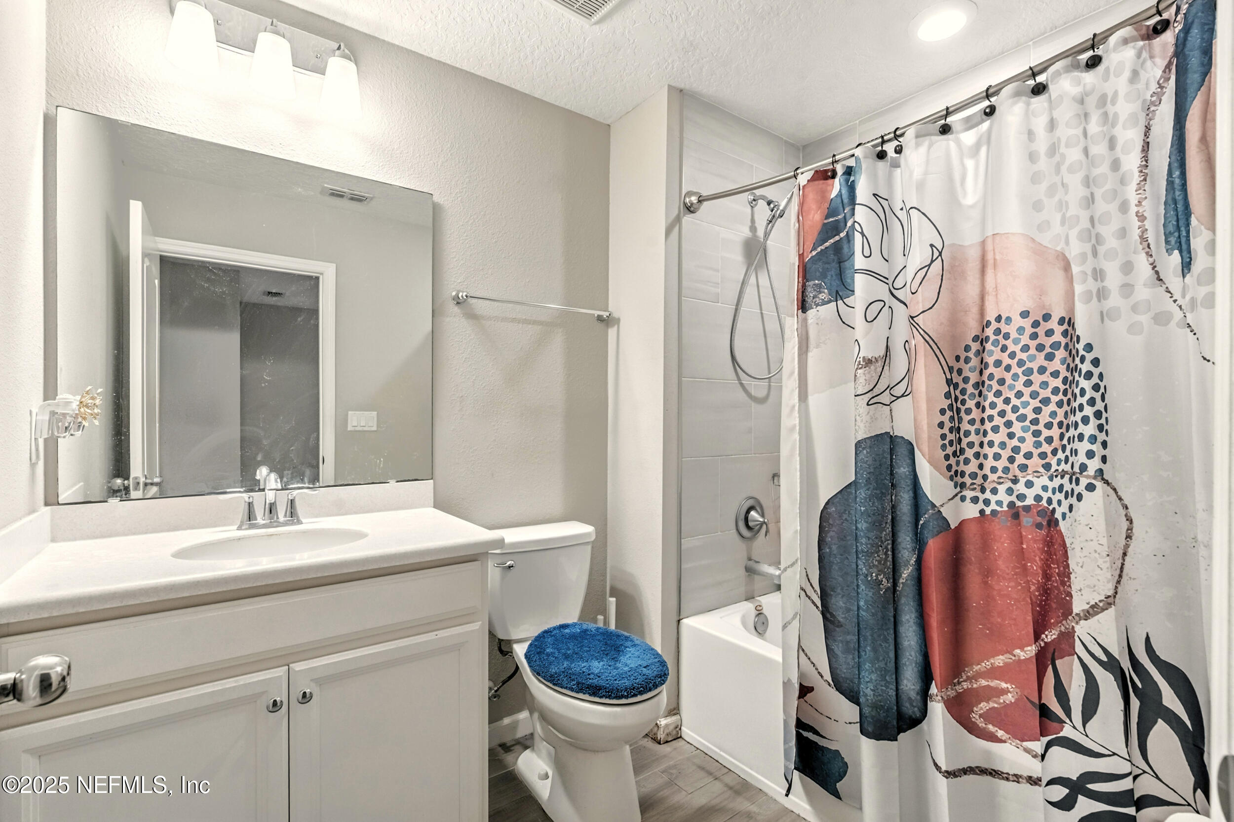 1330 Salt Ridge Avenue Jacksonville, FL 32218 - Photo 19 of 30 a bathroom with a sink a toilet and a mirror